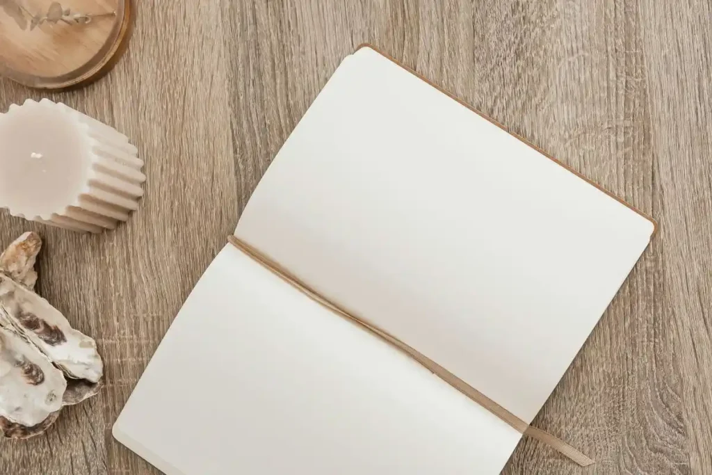white journal on wooden table