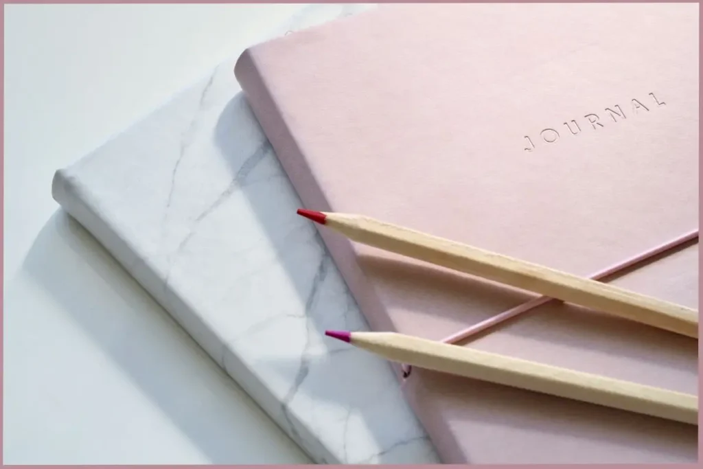two pencils on two journals representing basic journaling supplies for empty nester moms