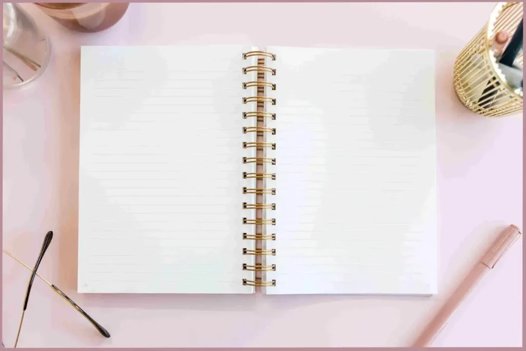 open journal with pen at the side- understanding the core of self-discovery journaling