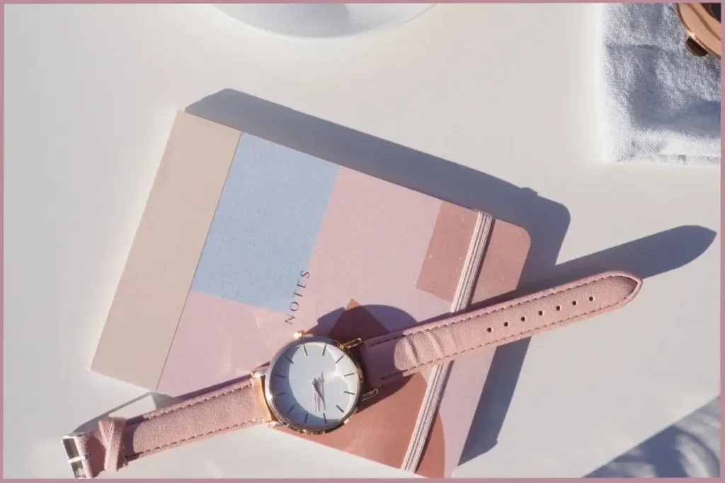 wrist watch lying on top of a journal - what to expect on your first week of journaling