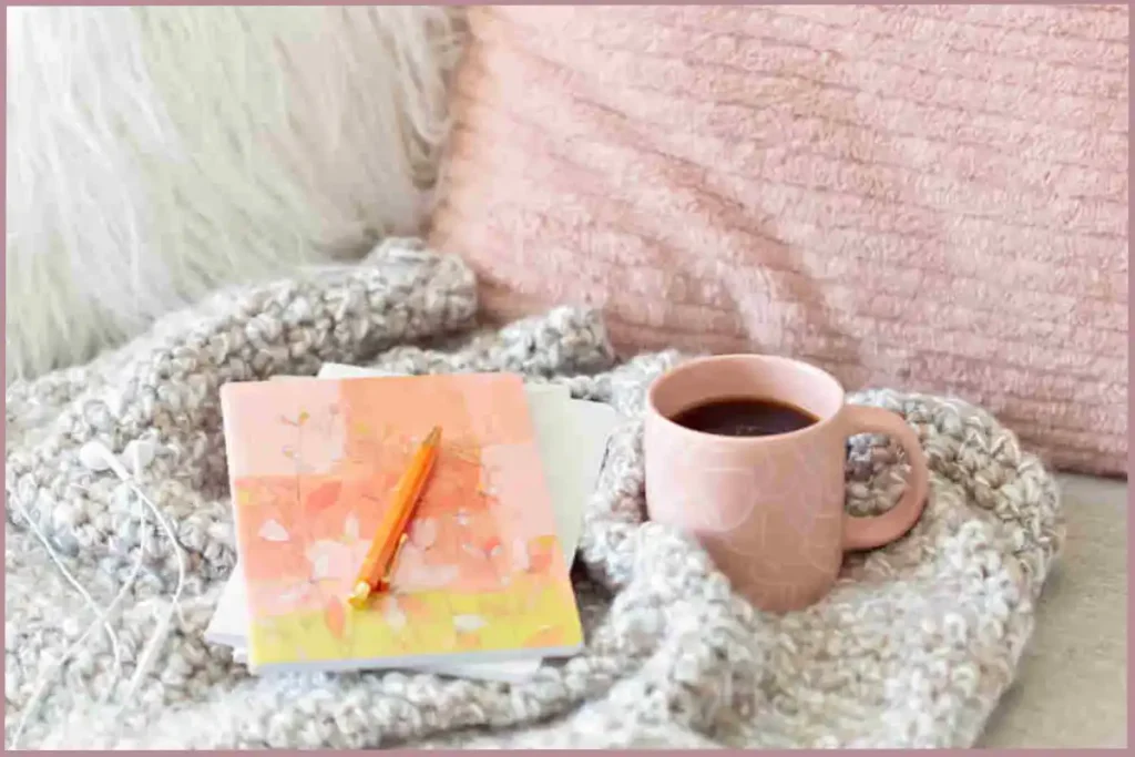 pink notebook on grey shawl to encourage self-reflection in empty nester moms