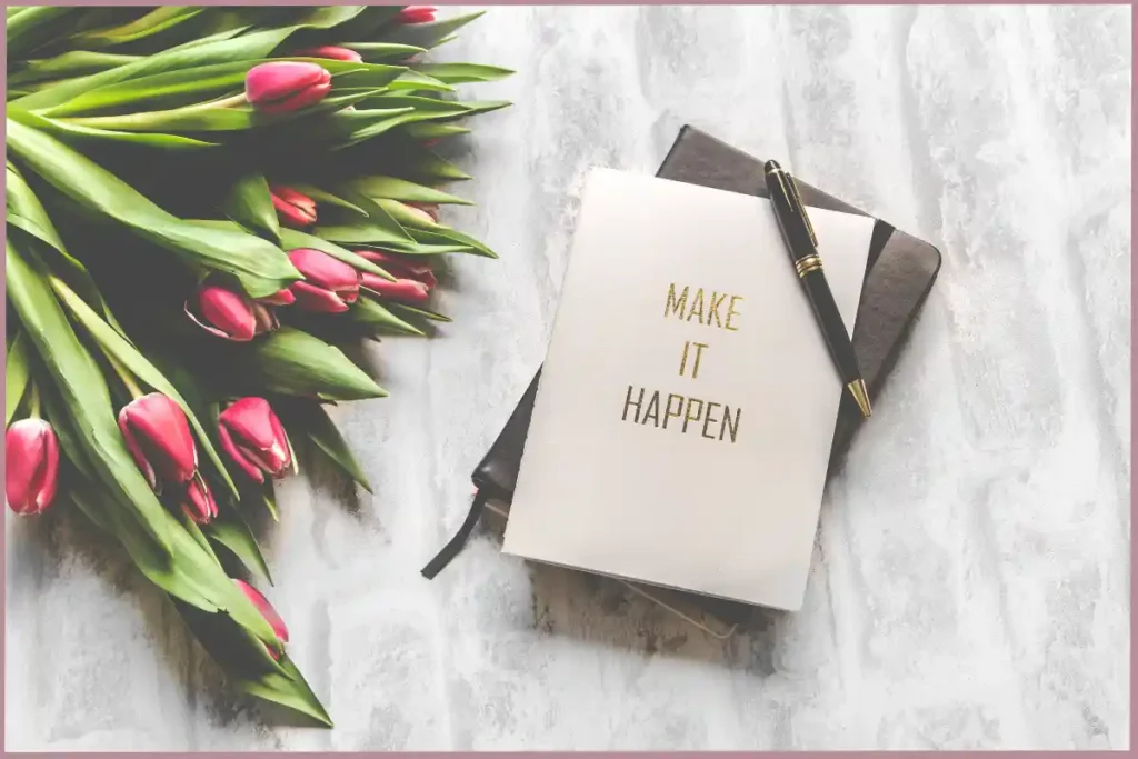 Book with the words 'make it happen' to encourage personal growth through journaling