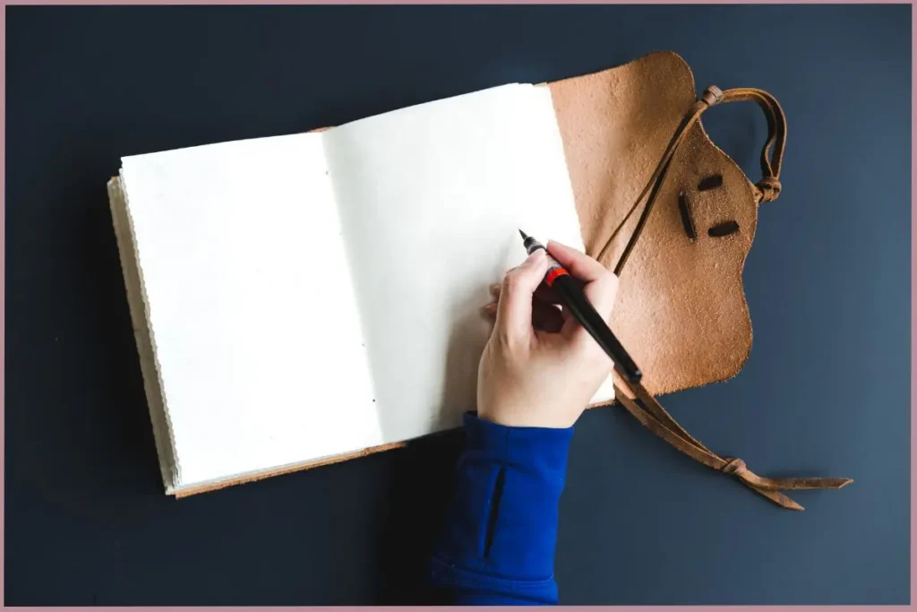 lady writing in a blank journal to lower stress and anxiety with journaling
