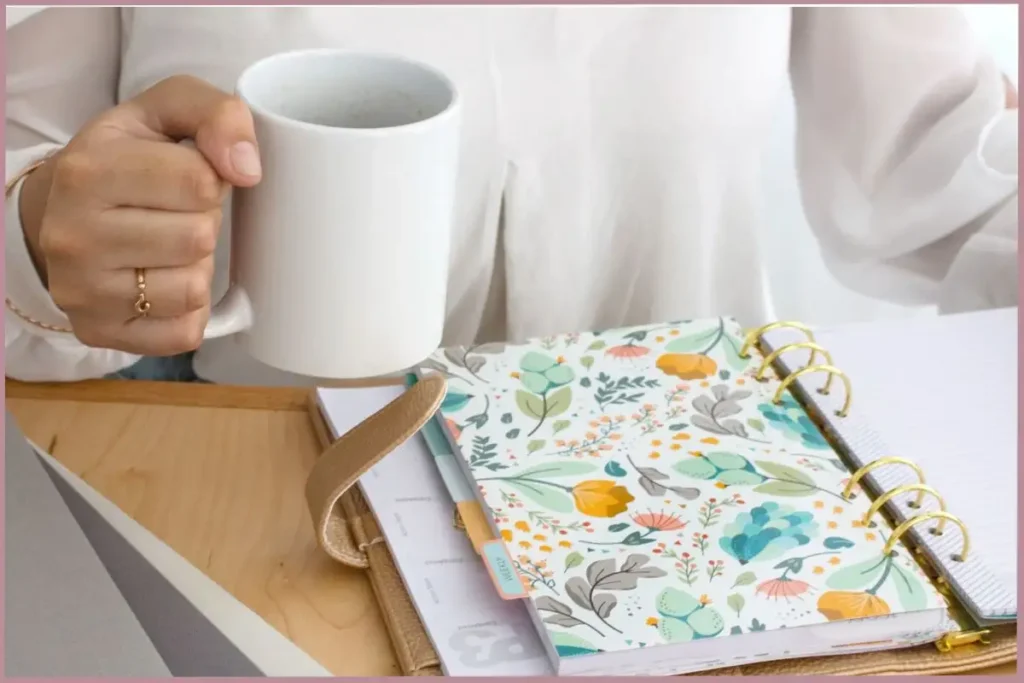 lady holding a cup of coffee while overcoming obstacles to consistency in journaling