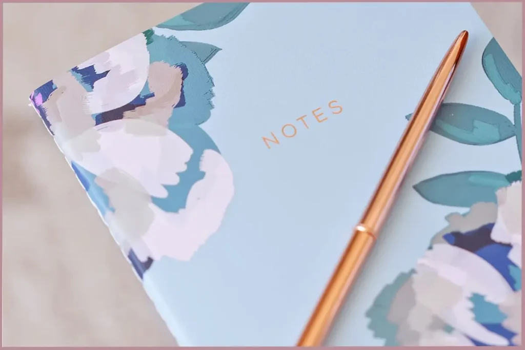 gold pen on blue journal - practical journaling techniques for beginners