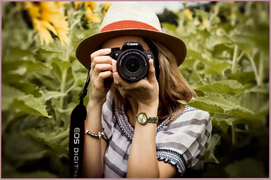 lady with camera clicking photos outdoors - creative self care ideas for empty nesters